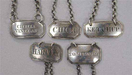 Five George III and later silver sauce labels;